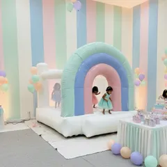 My pastel rainbow arch bouncer set up indoors for a toddler's birthday. This is a popular choice for themed parties and creates great photo opportunities.