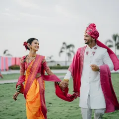 There's a special kind of magic in Marathi weddings. This candid shot of a couple, walking hand-in-hand in their traditional attire, is all about that feeling of 'pyar hua chupke se', a love that feels both grand and beautifully simple.