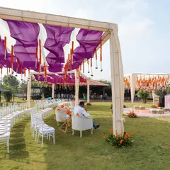 For the bride who dreamt of a purple Haldi, we brought her vision to life. This outdoor setup combines vibrant purple drapes with traditional orange marigolds, creating a unique and festive atmosphere for the ceremony.