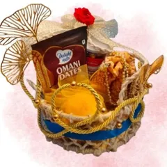 A clear product shot of the Divine Celebration Basket. The combination of the rustic jute, golden rope, and premium Omani dates creates a look of understated luxury.