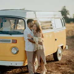 A warm, sun-kissed embrace against a classic yellow camper van in Goa. This shot perfectly captures the free-spirited, adventurous vibe of the shoot.
