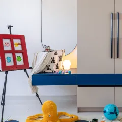 I call this "ordered chaos". For this kids' room, we focused on creating a furniture-free space that encourages play. The storage is minimal and efficient, designed to hold all the toys you see on the floor. A room should invite you to live in it, and sometimes the most beautiful design is the mess your kids make while playing.