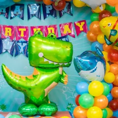 A roaring dinosaur and shark theme. We use large, colorful foil balloons and coordinated balloon arrangements to bring the underwater and prehistoric worlds to life.