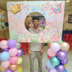 A fun photo booth frame with a butterfly and floral theme, perfect for guests to take pictures.