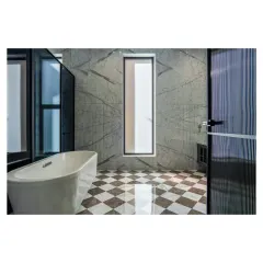 A bathroom that feels like a modern art gallery. I used book-matched marble slabs to create a stunning feature wall, complemented by a bold checkerboard floor and a freestanding bathtub for a truly luxurious feel.