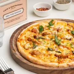 This is my take on a chicken pizza, with tender pieces of chicken, fresh basil, and plenty of melted mozzarella on our hand-stretched dough.
