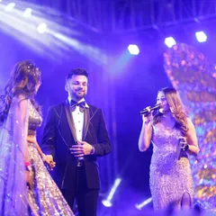 Interacting with the bride and groom on their Sangeet stage in Jaipur. I make sure to have personal, fun conversations with them to make them feel comfortable and celebrated.