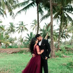 An intimate embrace amidst the serene greenery and towering palms of a destination shoot. We specialize in finding beautiful natural backdrops that complement a couple's story.