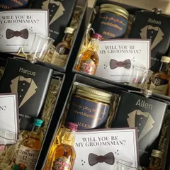 A closer look at my groomsmen proposal boxes. Each one contains a personalized hip flask, a custom scented candle, miniature whiskey bottles, and a proposal card.