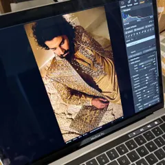 A behind the scenes glimpse of the final shots on the monitor. This shows the immediate result of the grooming work as seen through the photographer's lens during a men's fashion shoot.