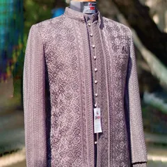 The same mauve-brown Jodhpuri suit, seen from a slightly different angle. The subtle shimmer of the fabric and the detailed texture are visible here.