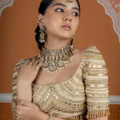 Our pearl and polki choker set, paired with statement bangles and rings, offers a look of pure royalty. This is a perfect example of contemporary craftsmanship meeting traditional design.