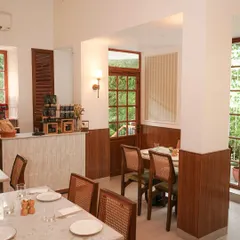 The interior of our Vasant Vihar cafe, featuring clean lines, wood paneling, and comfortable seating. It's a bright and airy space perfect for any time of day.