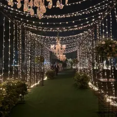 Imagine walking through a tunnel of sparkling fairy lights on your reception night. I design immersive lighting experiences like this to create a truly magical atmosphere for you and your guests.