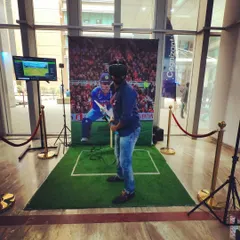 An employee at a Cognizant event gets ready to bat in our virtual cricket game. The setup is compact enough for an office lobby but delivers the full impact of being in a massive stadium.