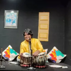 A relaxed moment during a performance in an intimate setting. The smile captures the joy I feel when the music connects with the audience.