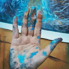 My hand covered in paint, held up against a work in progress. This image captures the essence of my process. It's messy, tactile, and deeply personal. For me, this is what it looks like when the universe holds my hand.