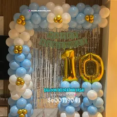 A classic balloon arch for a 10th birthday. The blue, white, and gold color scheme is bright and celebratory.