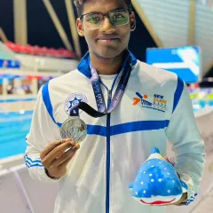 A close-up of champion swimmer Nithik Nathella with his silver medal from the Asian Age Group Championships. Fueling an elite athlete requires a precise, scientific approach to nutrition, which is a key part of my services.