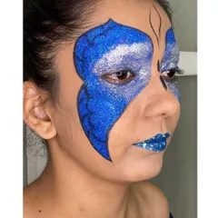 A side profile of the glitter butterfly look, showing the detailed wing pattern and how the makeup catches the light. This angle highlights the texture and dimension of the creative eye makeup.