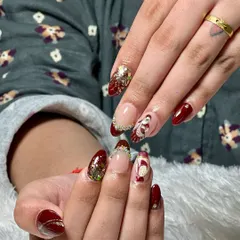 For our brides, we create truly one-of-a-kind nail art. This custom set for a wedding features a deep maroon base, sparkling glitter accents, and a hand-painted traditional bride design, making it a memorable part of the special day.