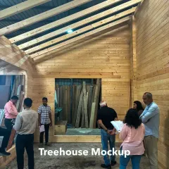 Our team reviewing a full-scale mockup of the prefabricated wooden treehouse for our Kanha project. This hands-on workshop visit is a critical step to finalize design details, material finishes, and service integrations before construction begins on site.