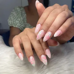 Holding on to summer with these dainty nails. This set features a soft pink ombré base on almond-shaped extensions with delicate, hand-painted pastel flowers.