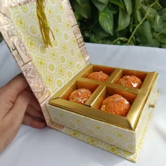 A closer look at the 4-piece laddoo candle gift box. The drawer-style box with a tassel is designed to feel luxurious and makes for a perfect festive present.