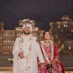 As confetti rains down against the backdrop of an illuminated palace, the couple shares their first moments as husband and wife. This is the kind of fairytale ending that marks a beautiful beginning, a memory of pure joy from a destination wedding in Jaipur.