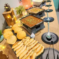 A delicious buffet spread featuring classic Indian comfort food like chole with bhature and naan. I make sure there's always hearty and yummy food for the parents too.