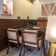 Details matter. I chose vintage-style chairs with cane webbing and rich, fluted wood paneling to add texture and character. These elements come together to create a sophisticated and comfortable workspace for my client.