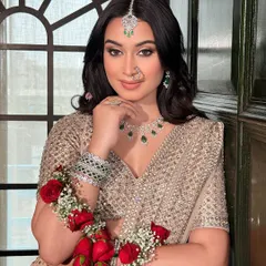 This pose highlights the fresh, dewy skin and the way the makeup works with the floral accessories. It’s a perfect example of a modern yet traditional bridal style.