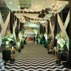 For a modern and chic Sangeet night, I designed this entrance with a bold black and white chevron walkway. The path is lined with glamorous disco balls and dramatic floral arrangements, setting a high energy tone for the party.