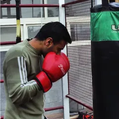 Training with a punching bag is essential for developing power and proper form in kickboxing. Here, I am working on my boxing technique.