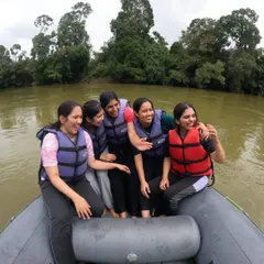 A group of friends having a laugh while on a rafting boat. Our Tadiandamol and Coorg trip includes exciting water activities.