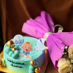 A beautiful blue cake to celebrate the arrival of a baby boy. This gift set pairs the decorated cake with a bouquet of fresh flowers wrapped in purple paper.