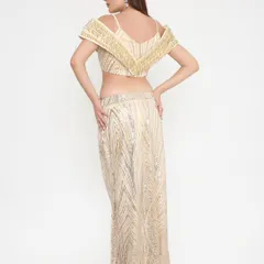 A look that's stunning from every angle. The back of our golden shimmer outfit shows the impeccable fit and detailed handwork that goes into every custom piece.