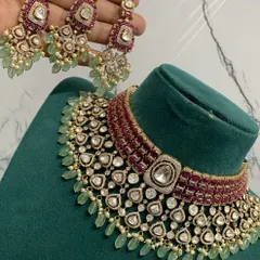 A close-up of the matching earrings for the premium ruby and mint bridal set, highlighting the detailed craftsmanship.