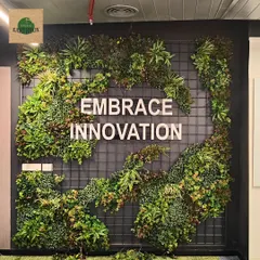 For this corporate office, we designed and installed a custom artificial green wall that frames their company motto. This zero-maintenance installation adds a powerful visual impact and a dose of nature to the modern workspace, making it a memorable feature for employees and visitors.