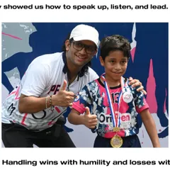 A coach celebrating with a young player who has won a medal. We teach our players to handle wins with humility and losses with courage.