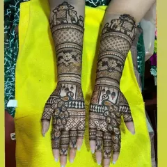 This full-arm bridal design showcases our expertise in traditional motifs. Notice the symmetrical patterns, the detailed elephants on the forearm, and the graceful peacocks on the palms.