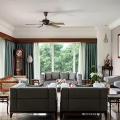 This living room is filled with the client's treasured antique furniture and art from their travels. We created a design that honors these pieces, blending traditional Indian elements with comfortable, contemporary living.
