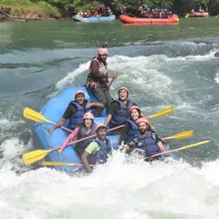 A team enjoying the thrill of the rapids during a rafting session in Dandeli. The excitement on their faces says it all!