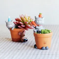 These cute cat-themed resin pots are perfect for tiny succulents. One design features a cat with a carrot, adding a playful and imaginative touch to your plant display.