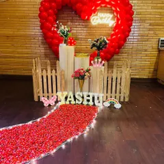 For a truly grand romantic gesture, I can create a stunning focal point like this large heart-shaped balloon arch. Paired with a glowing neon sign and a dreamy pathway of red petals, this setup is designed to make your proposal or special birthday celebration absolutely unforgettable.