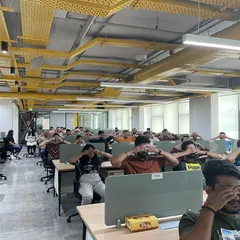 Yoga doesn't always require a mat. This is a chair yoga session in a typical office setting, where we are practicing techniques to release tension directly at the workstation. These sessions are designed for convenience and maximum impact on employee well-being.