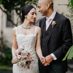 A beautiful portrait of Priya and Matthew after their wedding. Her elegant gown and his classic suit, combined with their loving gaze, create a picture of timeless grace.