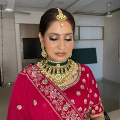 A closer look at this classic bridal makeup, focusing on the soft shimmer on the eyelids that complements the bold kohl liner. The skin is kept dewy and radiant for a fresh finish.