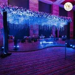 A custom-designed bar for the celestial-themed Sangeet, with a mirrored surface and a dramatic overhead installation of flowers and hanging crystals.