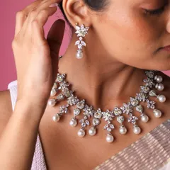For the bride seeking timeless elegance, this set combines the warmth of yellow sapphires, the luster of freshwater pearls, and the fire of diamonds. The floral motifs add a touch of delicate romance to this radiant bridal look.